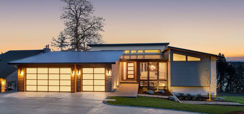 a charming home built in a lovely area with a garage, driveway, and maintained grass